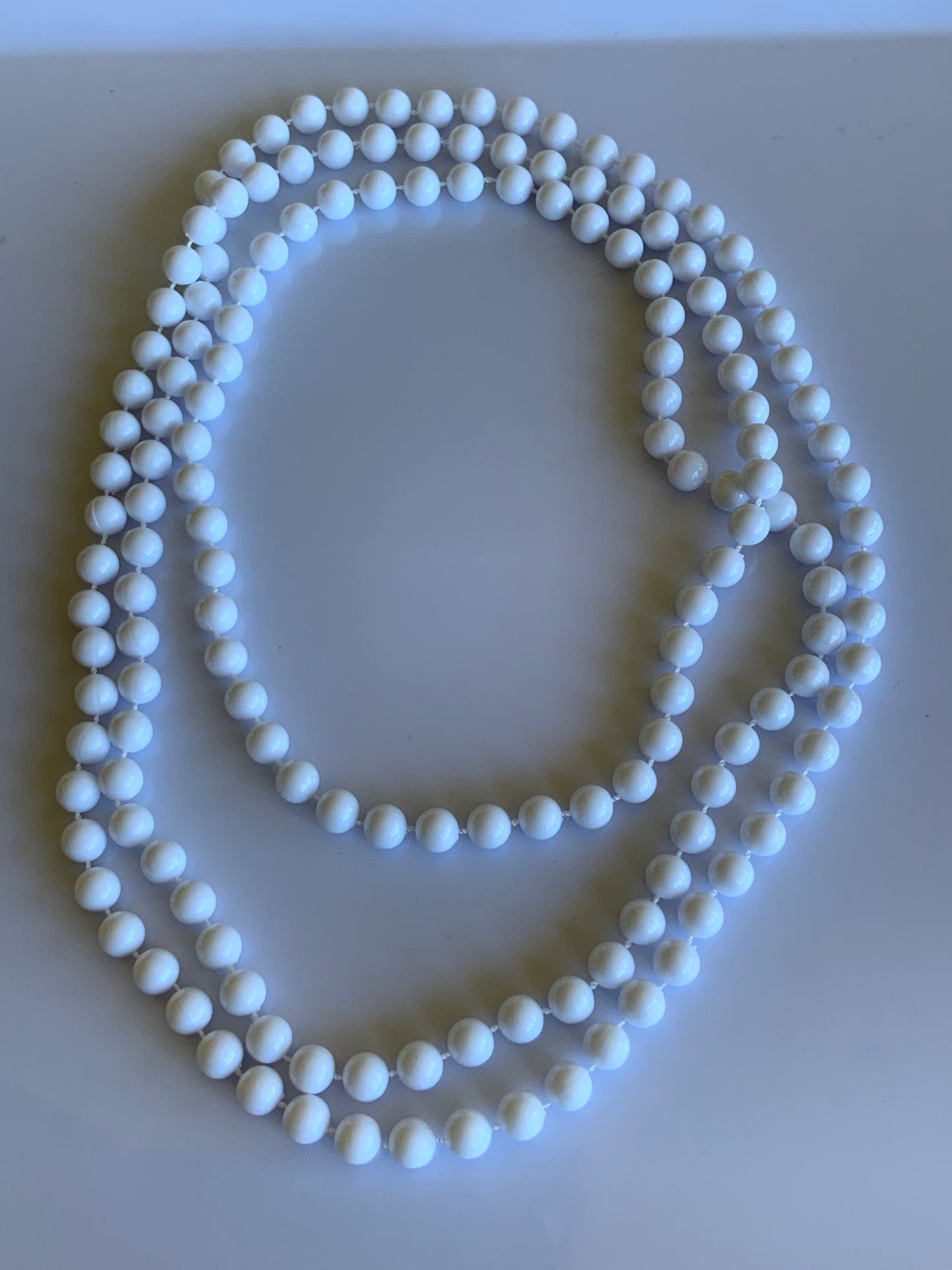 Long Strand White Bead Necklace slide over No Clasp
